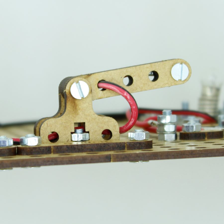 Close-up of a Wow We® MDF school project kit with switch and wiring